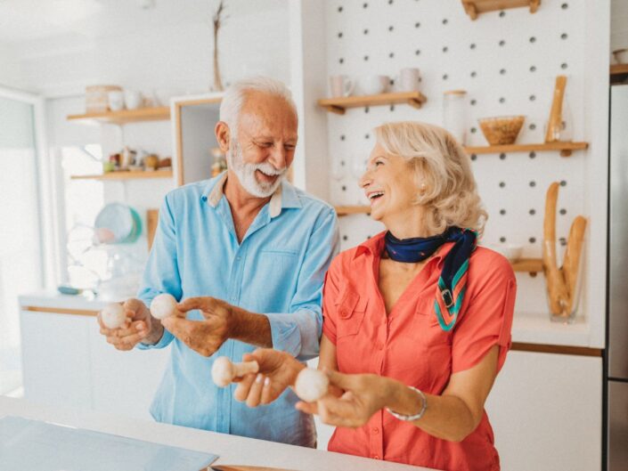 idősebb nő és férfi konyhában főz gomba