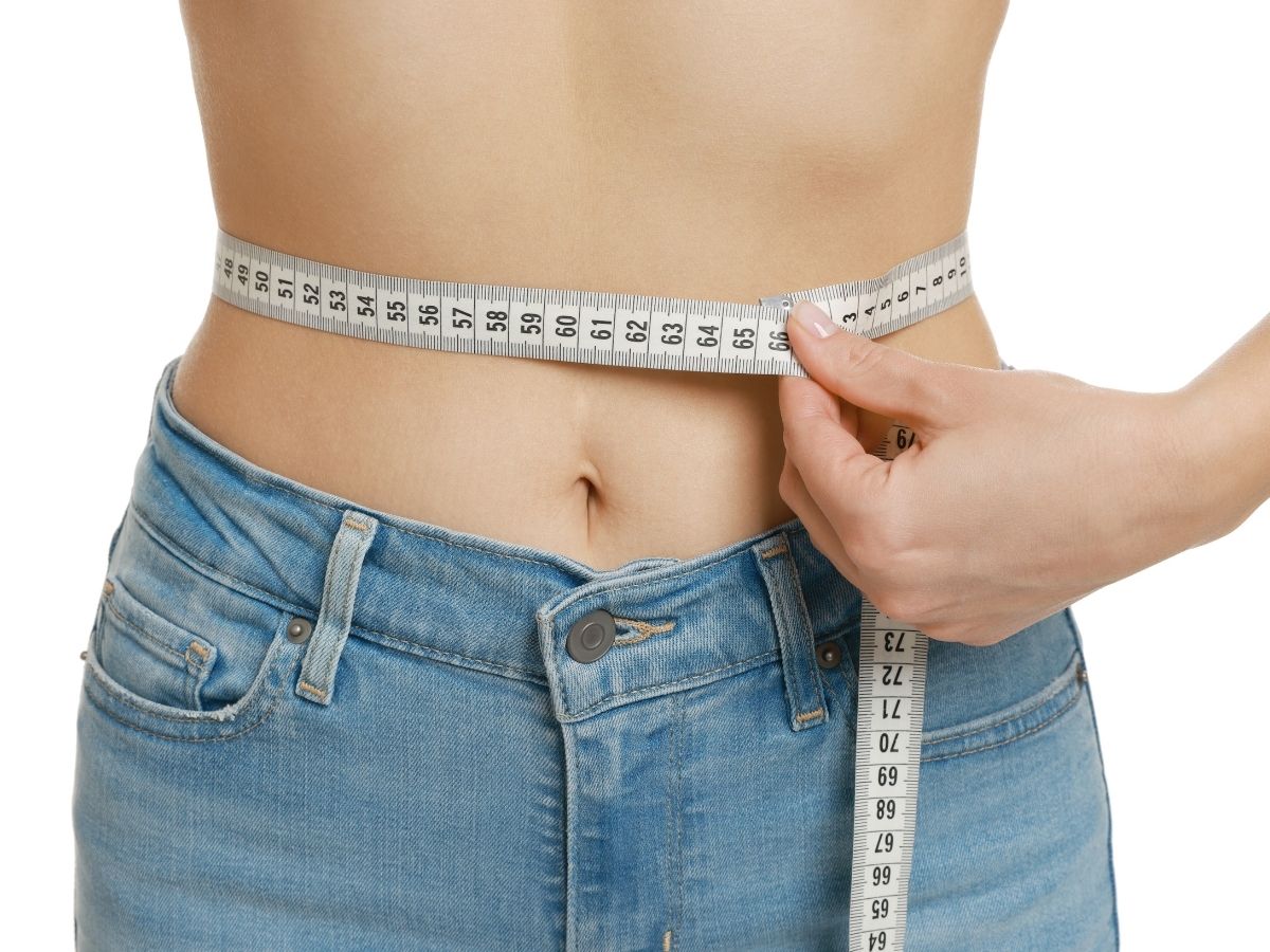 nő farmerban derekán centivel