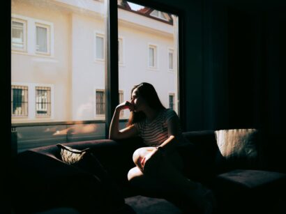 szomorú nő sötét szobában otthon depressziós