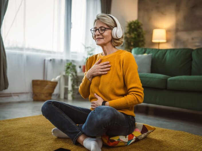 középkorú nő zenehallgatás meditálás manifesztáció otthon