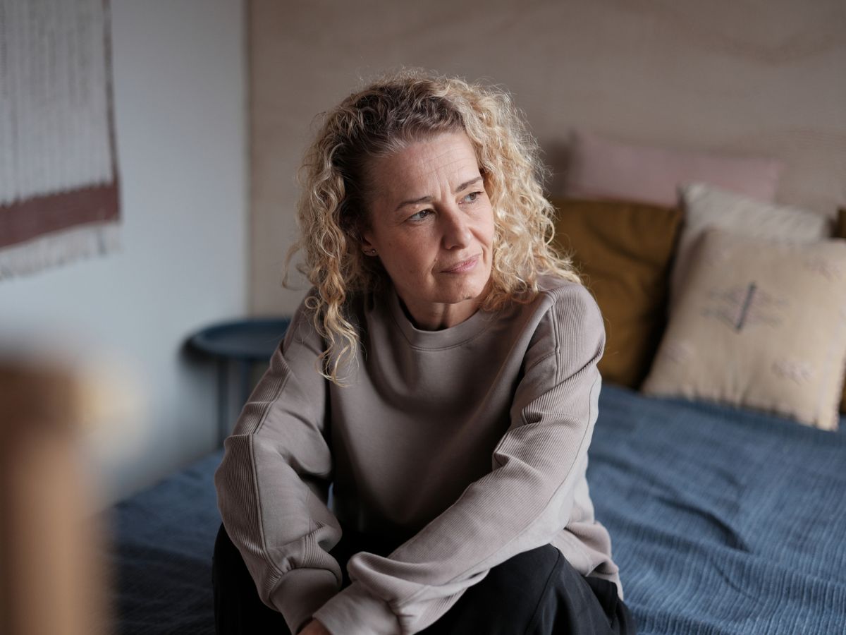 középkorú nő otthon szomorú mereng