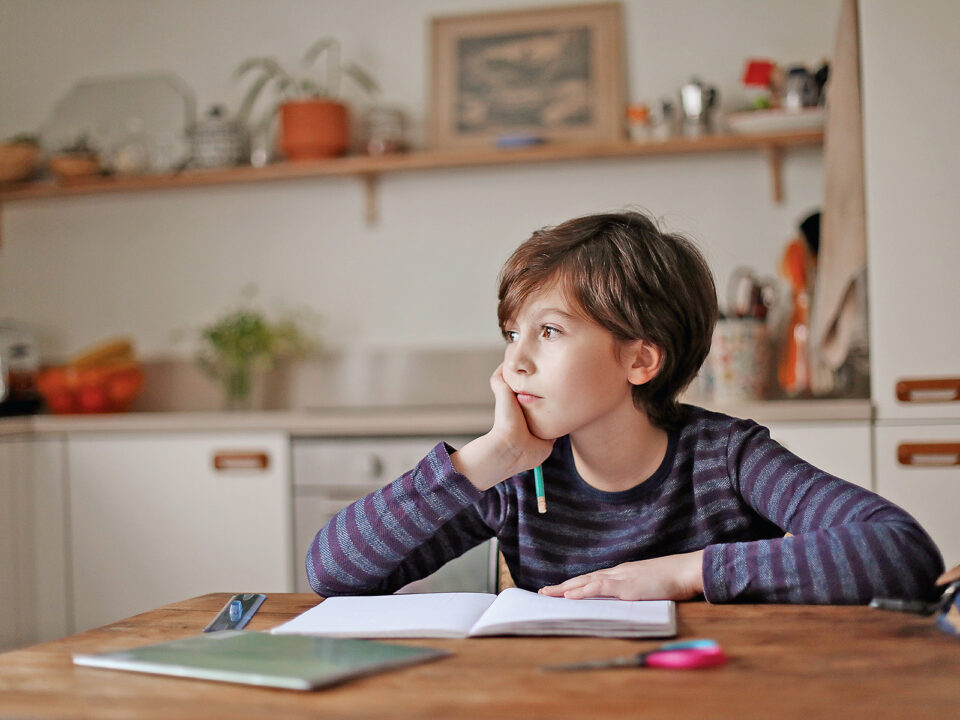 A 9 year old boy doing his homework in the kitchen - Nők Lapja tanul