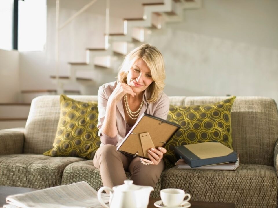 pozitiv-emlekek - Nők Lapja idősebb nő egy képet nézeget a nappaliban