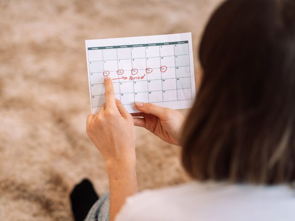 ciklus-tunetek - Nők Lapja Nő a menstruációs naptárt nézi és a kezdőnapra mutat