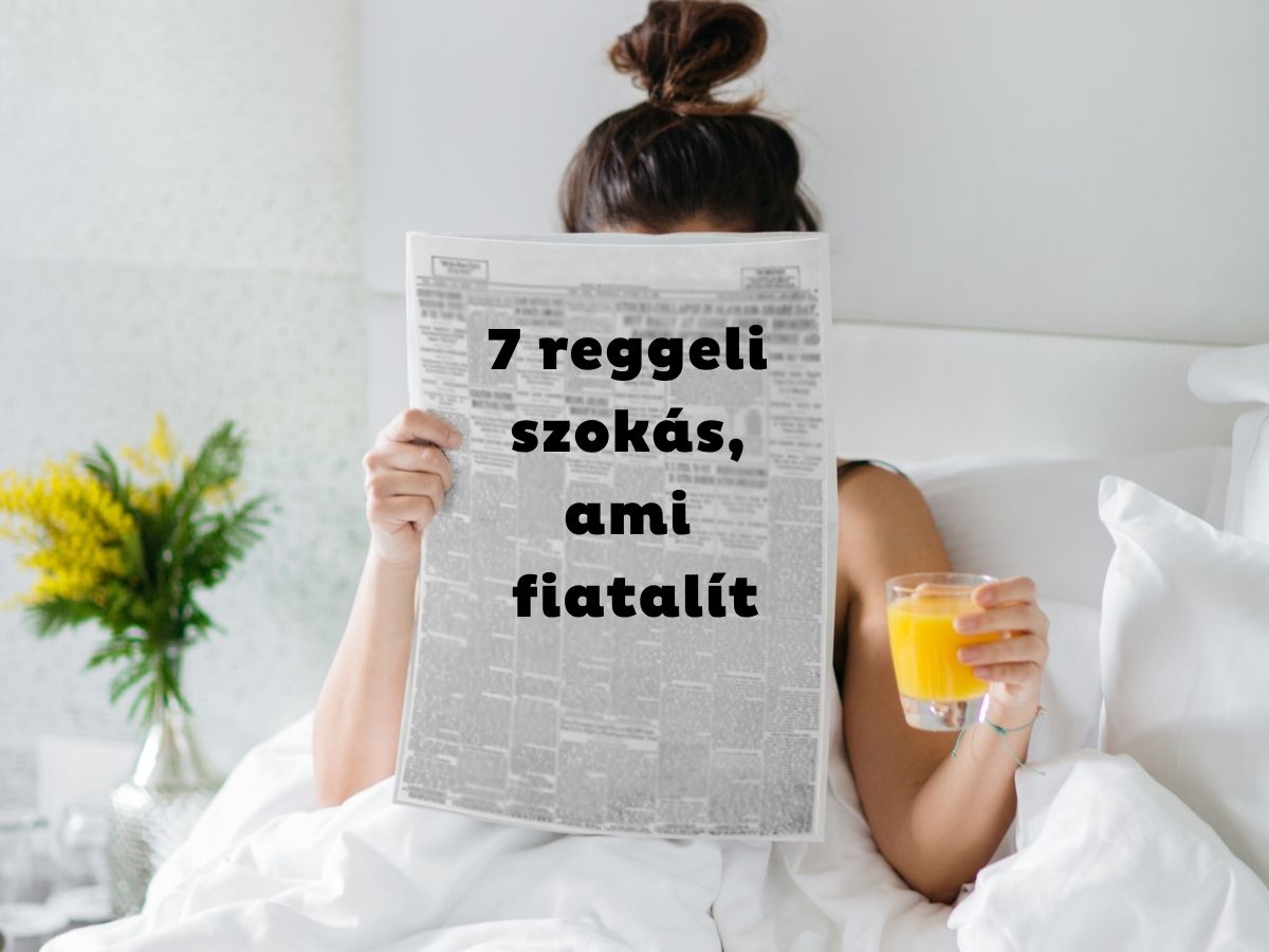 Nő ágyban ülve újságot tart maga elé, kezében narancslé